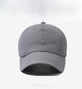 Detailed view of grey quick-dry baseball cap with white Consistance cursive embroidery