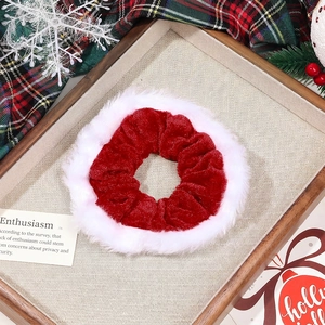 Detail view of festive red velvet and white faux fur scrunchie with Christmas ornaments