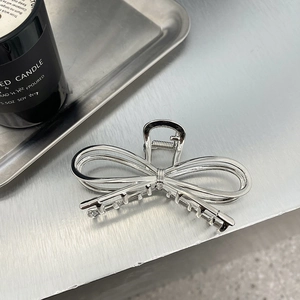 Silver bow-knot metal hair claw clip for women with minimalist aesthetic design