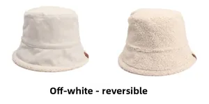 Detail view of beige reversible bucket hat showing smooth suede and fluffy lamb wool texture