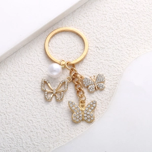 Elegant gold butterfly keychain with white pearl and rhinestone pendants for bags