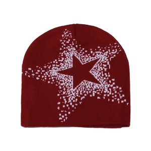 Detail of dark red knit beanie showing white pixelated star patterns and knit texture