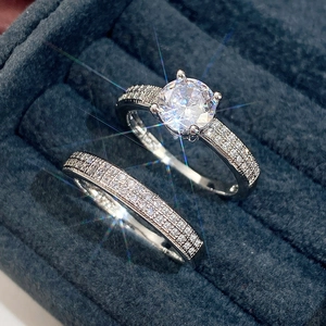 Classic round brilliant cut solitaire ring with pavé wedding band set in a velvet box