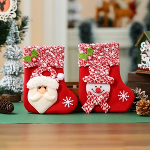 Detail of Christmas stocking ornaments featuring 3D Santa and Snowman on red felt