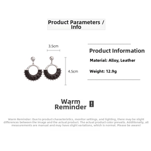 Detail of vintage geometric round hollow earrings with black leather and silver-tone alloy