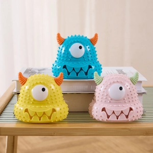 Detail showing the colorful monster pet toys with unique textured surface and squeak hole