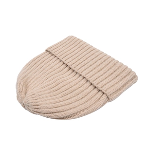 Close-up of beige ribbed knit beanie featuring thick wool texture and folded cuff detail