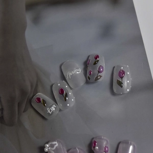 Detail of matte jelly nail stickers with red tulip patterns and white polka dots