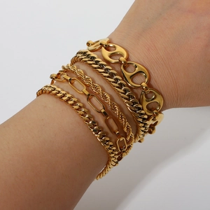 Set of 18K gold-plated stainless steel Cuban and snake chains worn on a wrist
