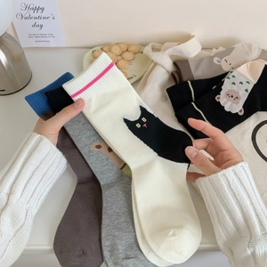 Flat lay of colorful combed cotton mid-tube socks with cute cartoon animal patterns