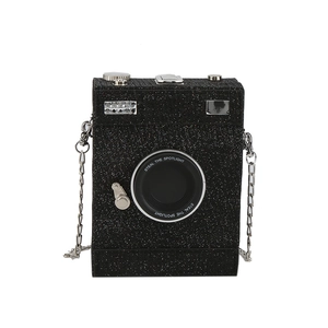 Sparkly black camera-shaped box bag with glitter finish and silver chain strap