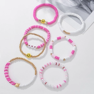 Detailed set of seven bohemian beaded bracelets featuring pink pearls and smiley faces