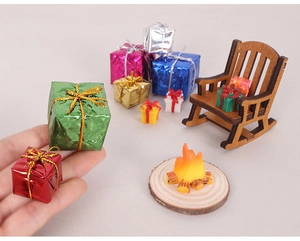Miniature Christmas gift boxes with glitter finish and tiny wooden rocking chair model