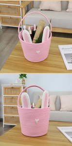 Detail of pink woven cotton Easter basket with rabbit ears used for organizing cosmetics