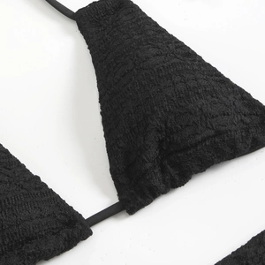 Close-up of black lace textured fabric and delicate straps for women beach bikini
