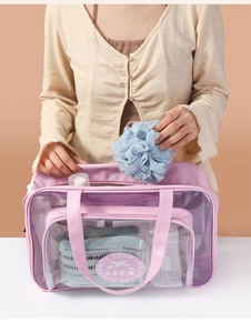 Detailed shot of pink mesh toiletry bag with double handles and Enjoy Your Life print