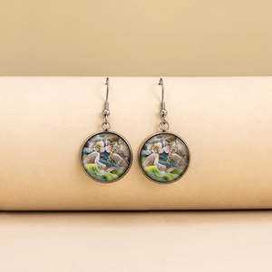 Detail of artistic round glass earrings with Van Gogh style painting and silver hooks
