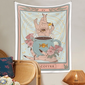 Detail of tarot-style coffee tapestry hanging in a cozy home setting with a rattan chair