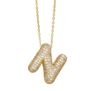 Macro shot of gold letter N balloon pendant necklace with pavé crystal inlay detailing