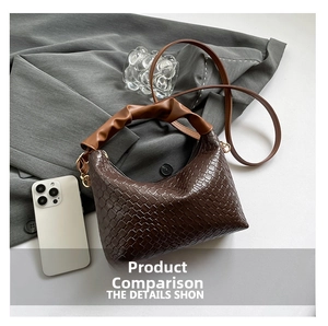 Detail of dark brown crescent bag showing fine woven texture and pleated caramel handle