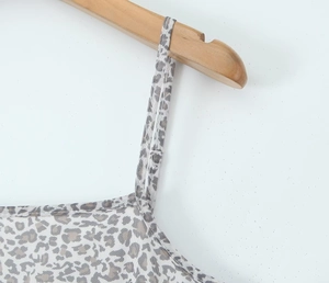 Details des französischen Kleids mit Leopardenmuster, dünnen Trägern und Ausschnitt am Bügel