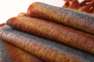Detailed macro view of soft orange and blue striped cashmere-like scarf fabric texture