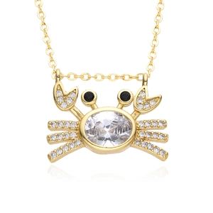 Close-up of a gold-plated crab pendant with a large oval zircon and pavé crystal details