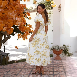 Detail of square neckline and puff sleeves on a floral midi dress with yellow prints