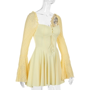 Close-up of square neckline with lace sleeves and tie waist on pale yellow dress