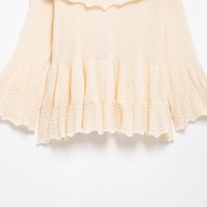 Chic beige V-neck knit sweater with elegant ruffle hem and openwork lace details