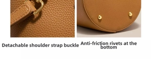 Detail of caramel lychee leather bucket bag with gold hardware and anti-wear bottom studs
