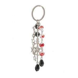 Detail of silver star pendant keychain with beads and chains on white background