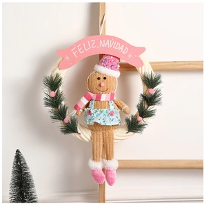Detail of gingerbread man Christmas wreath with pink sequins, faux pine, and Feliz Navidad banner