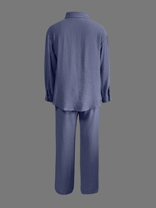 Detailed view of the fine crinkled texture on a casual long-sleeve shirt and pants set