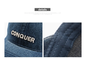 Detail showing 3D embroidered CONQUER text and stitched brim on denim baseball cap