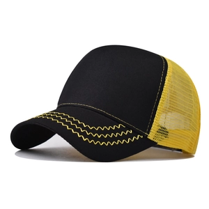 Detail view of the black and yellow mesh trucker hat with decorative wavy stitching