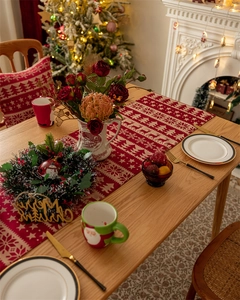 Christmas table runner with red snowflake deer pattern and festive tassel details