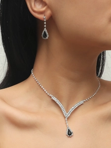 Detail showing the elegant water drop jewelry set with silver necklace and black pendant