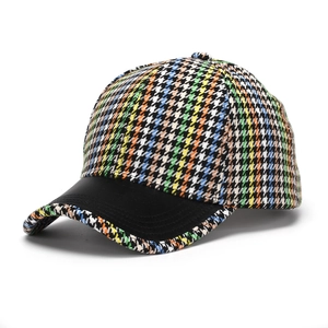 Detail of colorful houndstooth pattern woven fabric on a stylish structured baseball cap
