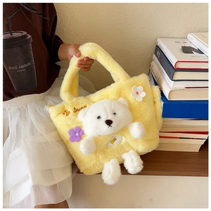 Detail showing the yellow faux fur plush handbag with a cute 3D bear and Sweet embroidery
