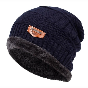 Winter knitted navy beanie with warm grey faux fur lining and a leather logo patch