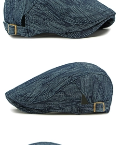 Detail of blue denim ivy cap featuring retro copper buckle and woven texture