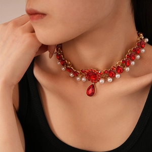 Close-up of vintage multilayer choker with red teardrop crystals and pearls on a model