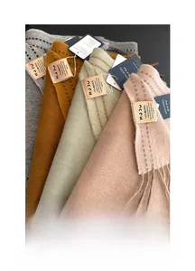 Detailed view of 100% Australian wool scarves with tassel edges in multiple colors