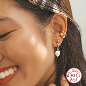 Elegant 925 sterling silver gold earrings with pearls and turquoise beads on model