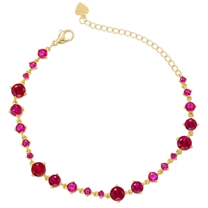 Adjustable gold chain bracelet with ruby red stones and heart charm on white background