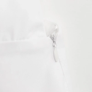 Close-up of a seamless white invisible zipper on backless crop top fabric