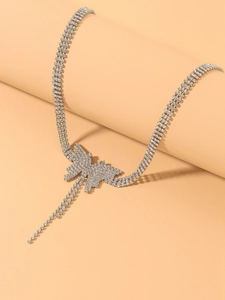 Close-up of triple-strand rhinestone butterfly choker with elegant double tassel details