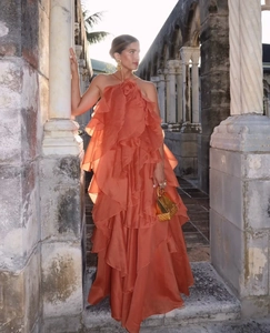 Detail of orange tiered halter maxi dress with layered ruffles and high-end texture