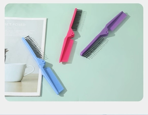 Close-up of portable folding hair combs in blue, pink, and purple for travel use